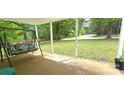 Relaxing covered porch with a swing, offering a serene outdoor living space and views of the yard at 6140 Barclay Ln, Clover, SC 29710