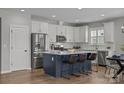 Bright kitchen featuring stainless steel appliances, white cabinets, and a stylish navy island at 6531 Wildbrook Dr, Charlotte, NC 28269