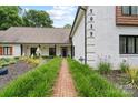 Inviting home with a brick walkway, attractive landscaping, and a classic painted brick facade at 7017 S Providence Rd, Waxhaw, NC 28173