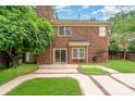 A beautiful brick home with a well-manicured lawn and custom patio design at 7031 Walton Heath Ln, Charlotte, NC 28277