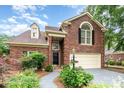 Charming brick home featuring a manicured lawn, two-car garage, and inviting front entrance at 7031 Walton Heath Ln, Charlotte, NC 28277