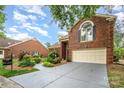 Charming brick home featuring a manicured lawn, two-car garage, and inviting front entrance at 7031 Walton Heath Ln, Charlotte, NC 28277