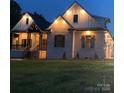 Beautifully lit home at night with professionally landscaped front yard at 867 Bellegray Rd, Clover, SC 29710
