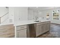 Bright, new construction kitchen island with stainless steel appliances and modern sink at 9214 Delancey Ln # 62, Concord, NC 28027