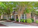 Attractive brick exterior of a two-story home with well-maintained landscaping and sidewalk at 10027 Juniper Trace Dr, Charlotte, NC 28277