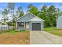 Single-Gathering home featuring gray siding, attached garage, and front yard at 101 Churchill Dr, Kings Mountain, NC 28086