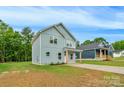 Light blue home featuring a well manicured lawn, and a clean concrete driveway on a clear sunny day at 103 Churchill Dr, Kings Mountain, NC 28086
