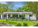 Charming one story home with a lush front yard, white picket fence, and beautiful landscaping at 106 Phifer St, Fort Mill, SC 29715
