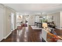 Open-concept living space with hardwood floors, stylish decor, and seamless flow to the kitchen at 106 Phifer St, Fort Mill, SC 29715