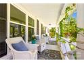 Inviting front porch with comfortable wicker chairs and charming decor, creating a relaxing outdoor space at 106 Phifer St, Fort Mill, SC 29715