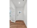 Bright entryway featuring wood flooring and a white front door with sidelights at 11131 Cardinal Creek Ave, Charlotte, NC 28215