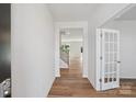 Entryway with wood floors leading to staircase, living area and a glass door to the side at 11131 Cardinal Creek Ave, Charlotte, NC 28215