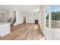 Living room featuring wood flooring, fireplace, staircase, and sliding glass doors at 11131 Cardinal Creek Ave, Charlotte, NC 28215