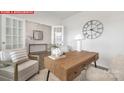 Bright home office with a wooden desk, decor, neutral walls, and large windows allowing for natural light at 11131 Cardinal Creek Ave, Charlotte, NC 28215