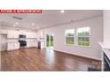 Spacious open-concept design with stainless steel appliances and hardwood flooring throughout the main living area at 11212 Cardinal Creek Ave, Charlotte, NC 28215