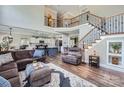 Spacious living room featuring a staircase, hardwood floors, comfortable seating, and an open design at 113 Dairy Farm Rd, Mooresville, NC 28115