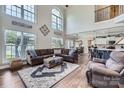 Spacious living room with high ceilings, large windows, and comfortable seating at 113 Dairy Farm Rd, Mooresville, NC 28115
