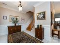Elegant foyer with staircase, neutral walls, decorative rug, and wood accents exudes warmth at 139 Harper Lee St, Davidson, NC 28036