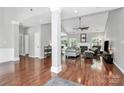 Spacious living room featuring hardwood floors, fireplace, ceiling fan, and neutral paint tones at 13930 Wild Heather Ct, Charlotte, NC 28273