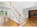 Grand foyer featuring a sweeping staircase, hardwood floors, and elegant design at 15216 Ballantyne Country Club Dr, Charlotte, NC 28277