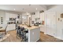 Bright kitchen featuring white cabinets, stainless steel appliances, and a large island with bar seating at 1708 Speartip Ln, Denver, NC 28037