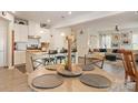Open-concept kitchen and dining area with a granite countertop island and modern lighting fixtures at 1708 Speartip Ln, Denver, NC 28037