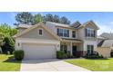 Attractive two-story home with neutral siding, a two-car garage, and a neatly maintained lawn at 1814 Still Water Ln, Fort Mill, SC 29707