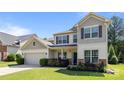 Inviting two-story home featuring a manicured lawn, neutral siding, and an attached two-car garage at 1814 Still Water Ln, Fort Mill, SC 29707