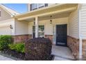 Inviting front porch featuring stone accents, decorative lighting, and well-maintained landscaping at 1814 Still Water Ln, Fort Mill, SC 29707