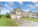 Beautiful two-story home featuring a spacious driveway, two car garage, and manicured front yard at 189 Fesperman Cir, Troutman, NC 28166