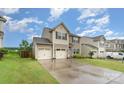 Beautiful two-story home featuring a spacious driveway, two car garage, and manicured front yard at 189 Fesperman Cir, Troutman, NC 28166