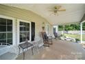 Inviting covered porch featuring rocking chairs and a view of the well-manicured landscaping at 2291 Howell Rd, Midland, NC 28107