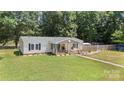 Aerial shot of a charming home featuring a cozy front porch and well-maintained lawn, perfect for outdoor enjoyment at 2291 Howell Rd, Midland, NC 28107