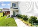 Inviting front entrance with a green door, landscaped garden, and well-manicured lawn at 2636 Forest Grove Ct, Charlotte, NC 28269