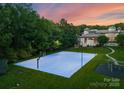 Outdoor basketball court next to the house with lighting for night games and playground at 2926 Crane Rd, Waxhaw, NC 28173