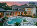Luxury pool and spa on a rear patio with travertine tile and stone columns at 2926 Crane Rd, Waxhaw, NC 28173