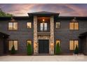 Grand front entrance with stone pillars and a double-door entry, exuding sophistication at 3020 Brooks Mill Ln, Wingate, NC 28174