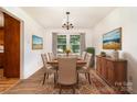 Bright dining room with a dining table set, elegant chandelier and natural lighting at 4250 N Center St, Hickory, NC 28601