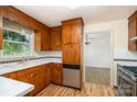 Functional kitchen with wood cabinets, stainless steel dishwasher, and adjacent dining area at 4250 N Center St, Hickory, NC 28601