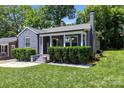 Charming brick home featuring a cozy front porch with well-manicured landscaping and inviting curb appeal at 432 4Th Street Sw Pl, Hickory, NC 28602