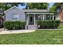 Charming brick home featuring a cozy front porch with well-manicured landscaping and inviting curb appeal at 432 4Th Street Sw Pl, Hickory, NC 28602