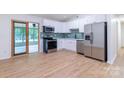 Updated kitchen featuring stainless steel appliances, modern cabinetry, and a stylish backsplash at 5233 Great Wagon Rd, Charlotte, NC 28215
