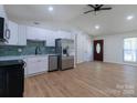 Bright, updated kitchen featuring modern appliances, white cabinets, and wood-look flooring at 5233 Great Wagon Rd, Charlotte, NC 28215