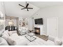 Spacious living room featuring vaulted ceilings, a fireplace and built-in shelving at 6204 Half Dome Dr, Charlotte, NC 28269