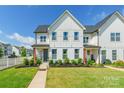 Inviting townhome with charming landscaping, manicured lawn, and cozy front porch decor at 651 Melville Dr, Rock Hill, SC 29732