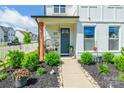 Charming front porch with cozy swing, landscaped plants, and a welcoming entrance at 651 Melville Dr, Rock Hill, SC 29732