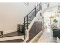 Stylish staircase with black iron railings, decorative wallpaper, and modern design at 651 Melville Dr, Rock Hill, SC 29732