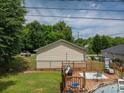 Backyard featuring a wooden deck, above-ground pool, and green lawn at 792 Carolina Mill Cir, Lincolnton, NC 28092