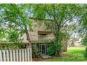 Exterior view of a house with a screened patio, balcony, and mature trees at 8005 Horse Chestnut Ln, Charlotte, NC 28277
