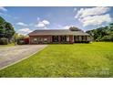 Beautiful single-story brick home with lush green lawn and long driveway at 801 Witmore Rd, Wingate, NC 28174
